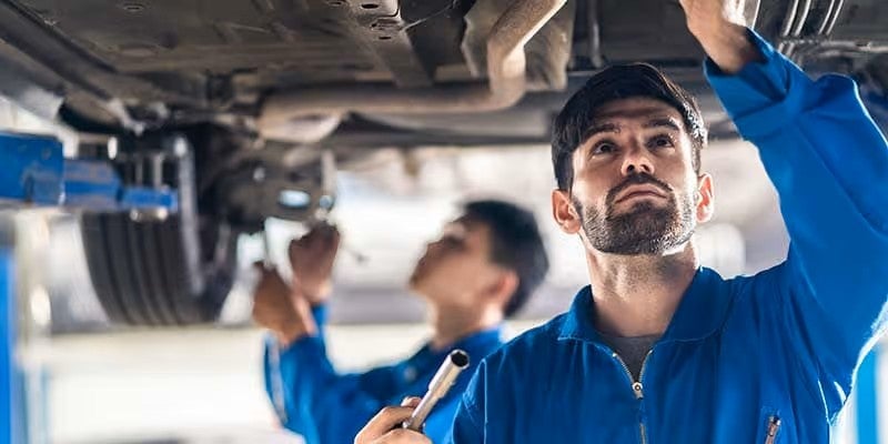 Mechanic working under car